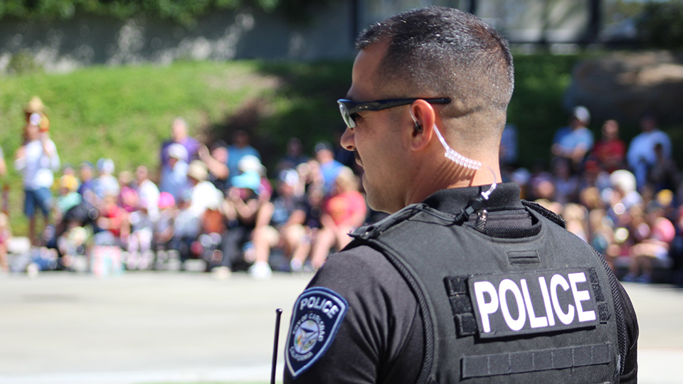 Police officer addressing crowd at open house